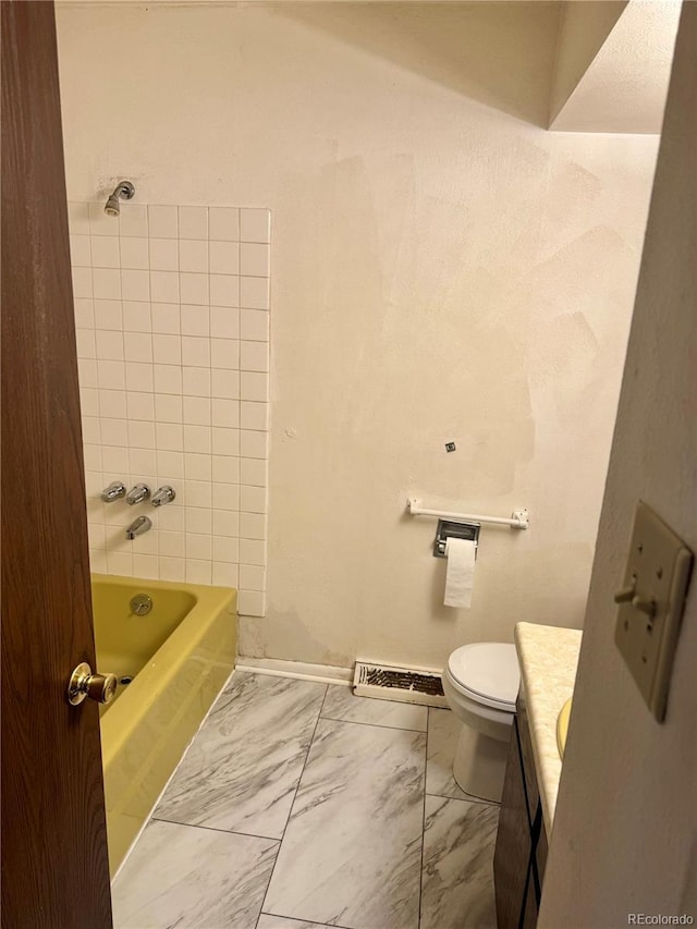 full bathroom with vanity, toilet, and tiled shower / bath combo