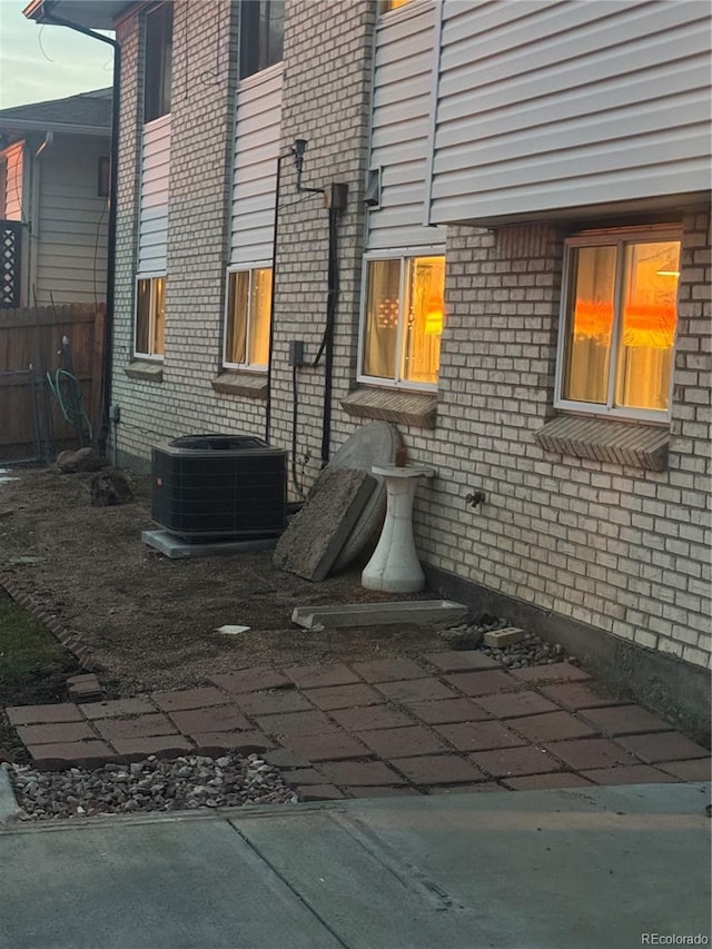 view of property exterior with a patio and central AC unit