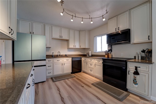 701 Tucson, Aurora, CO 80011 - kitchen with black appliances, a sink, light wood-type flooring, and white cabinetry