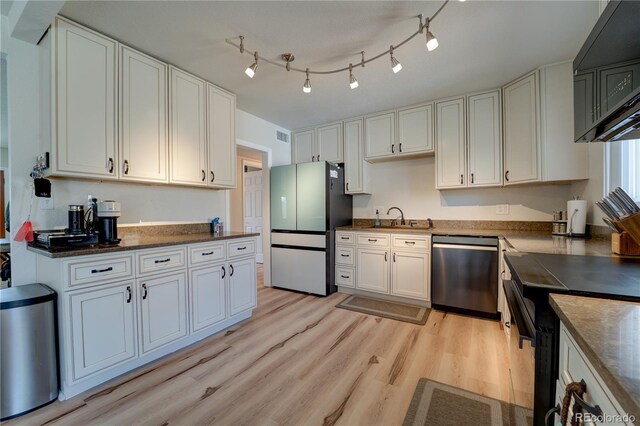 701 Tucson, Aurora, CO 80011 - kitchen featuring dishwasher, freestanding refrigerator, a sink, light wood-style floors, and black stove