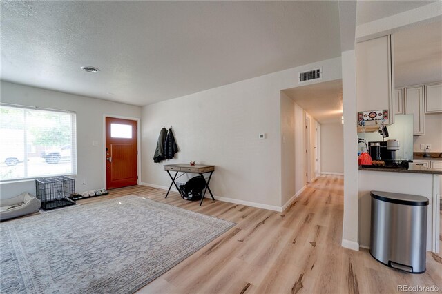 701 Tucson, Aurora, CO 80011 - entryway with light wood-style floors and baseboards