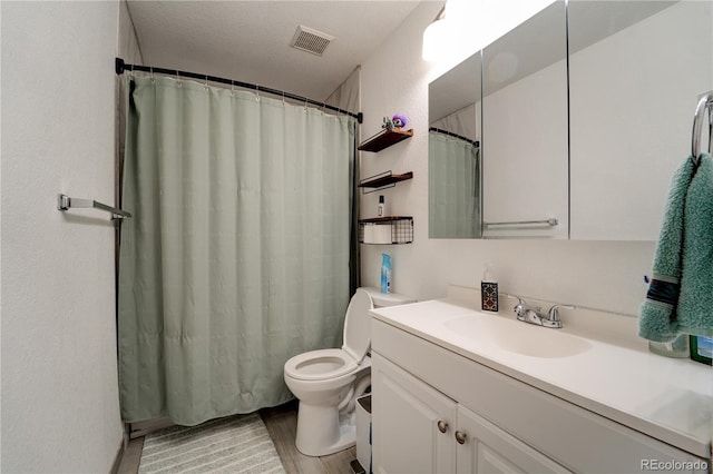 701 Tucson, Aurora, CO 80011 - full bath featuring vanity, toilet, wood finished floors, and a shower with curtain