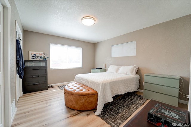 701 Tucson, Aurora, CO 80011 - bedroom with light wood-type flooring and baseboards