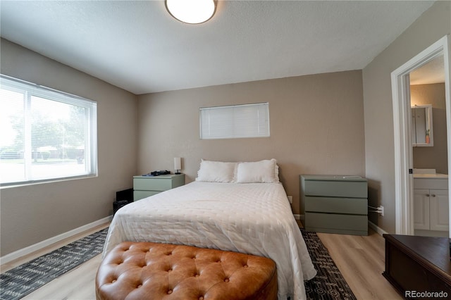 701 Tucson, Aurora, CO 80011 - bedroom featuring light wood finished floors and baseboards