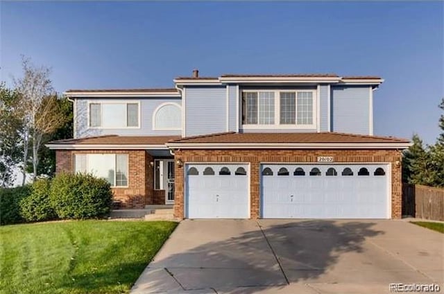 front facade featuring a front lawn and a garage