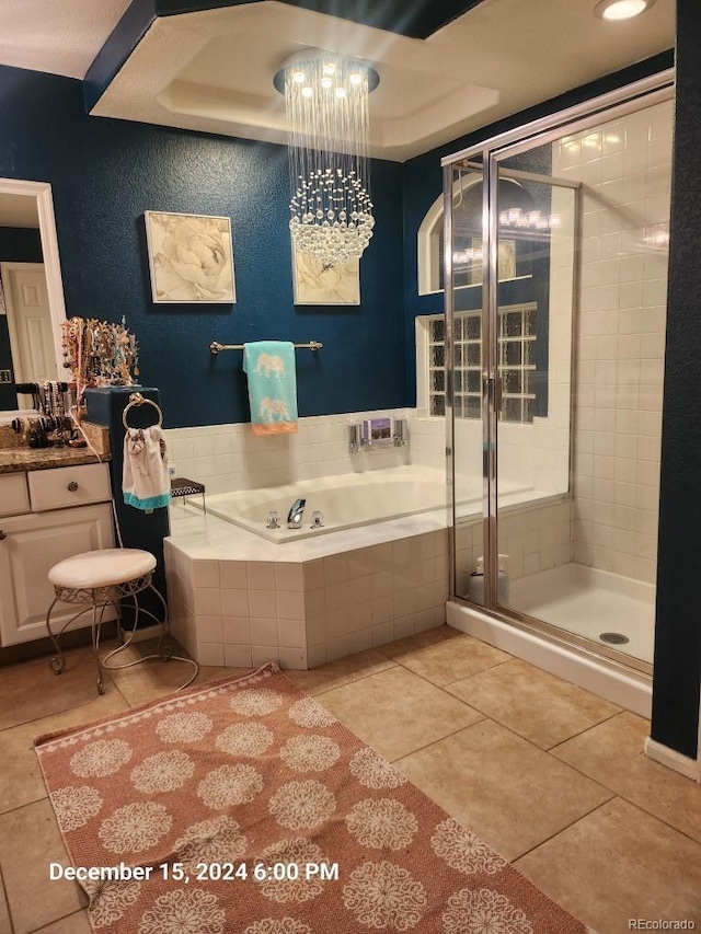 bathroom featuring separate shower and tub, a raised ceiling, tile patterned flooring, and vanity