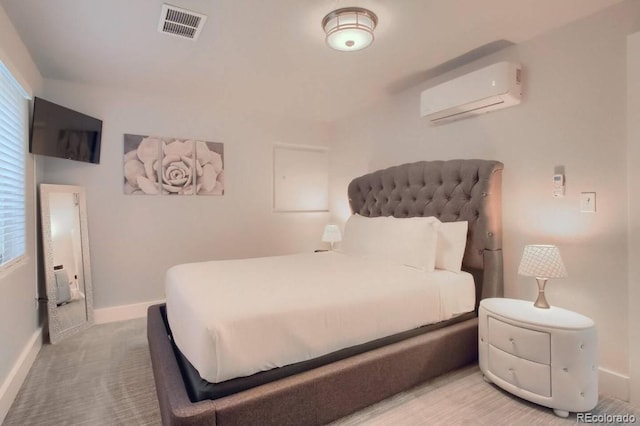 bedroom featuring a wall mounted air conditioner and carpet flooring