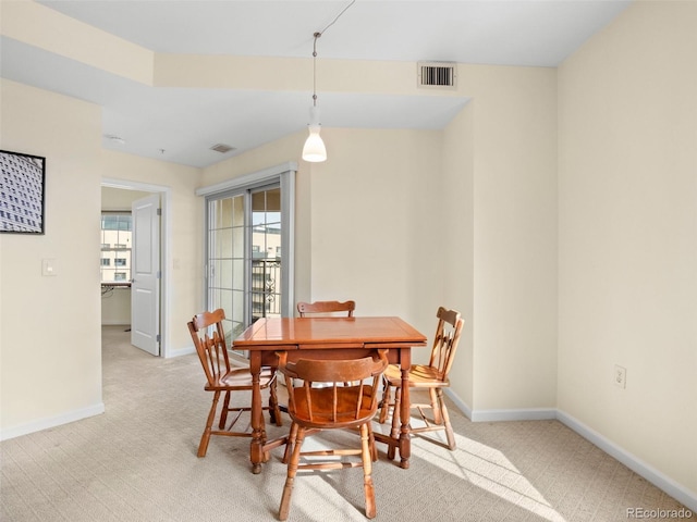 dining area featuring light colored carpet, baseboards, and visible vents