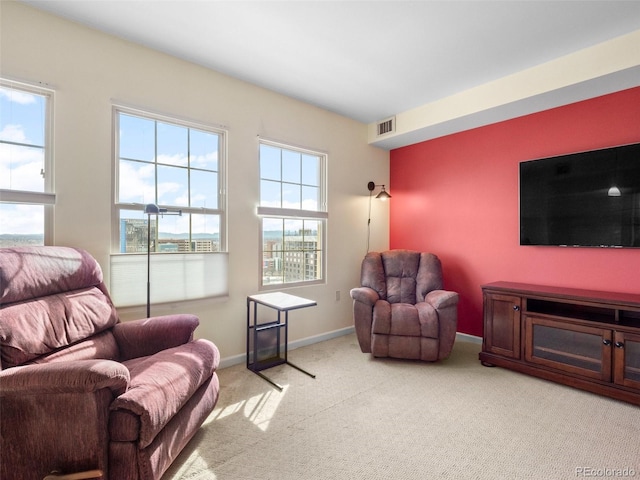 living room featuring visible vents, baseboards, and light colored carpet