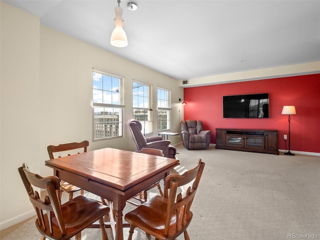 dining room with baseboards, carpet floors, and visible vents