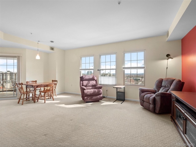 interior space featuring light carpet, visible vents, and baseboards