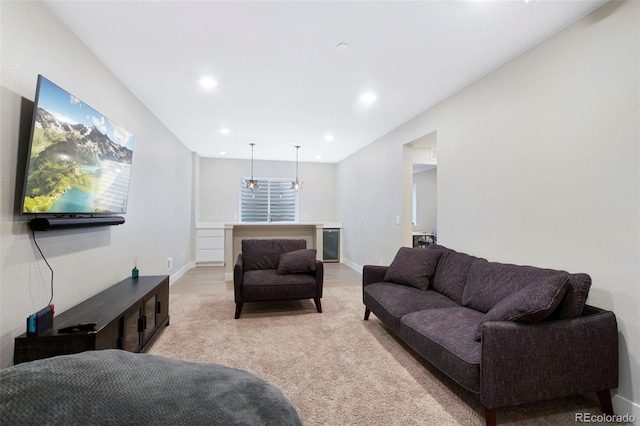 living room featuring recessed lighting, baseboards, and light carpet