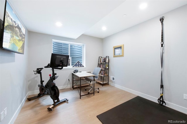 workout area with recessed lighting, baseboards, and wood finished floors