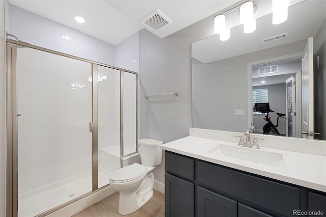 bathroom featuring toilet, visible vents, a shower stall, and wood finished floors