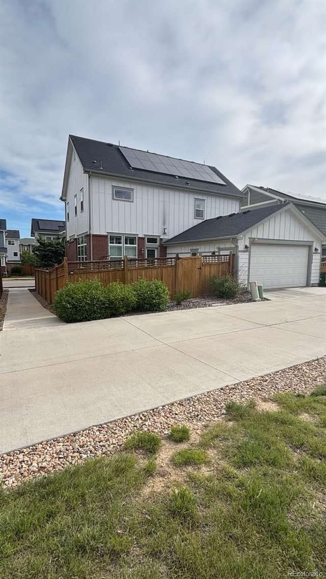 5404 W 95th Pl, Westminster, CO 80020 - view of front of house with board and batten siding, concrete driveway, and a garage