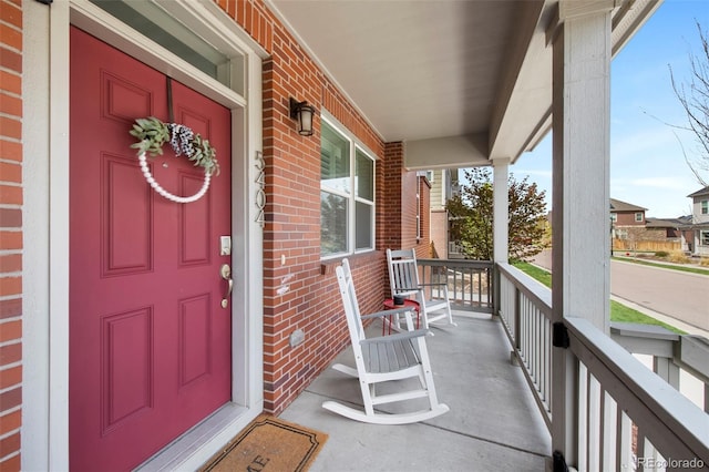 5404 W 95th Pl, Westminster, CO 80020 - view of exterior entry featuring covered porch and brick siding