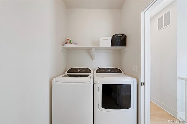5404 W 95th Pl, Westminster, CO 80020 - washroom with washing machine and dryer, light wood-style flooring, and baseboards