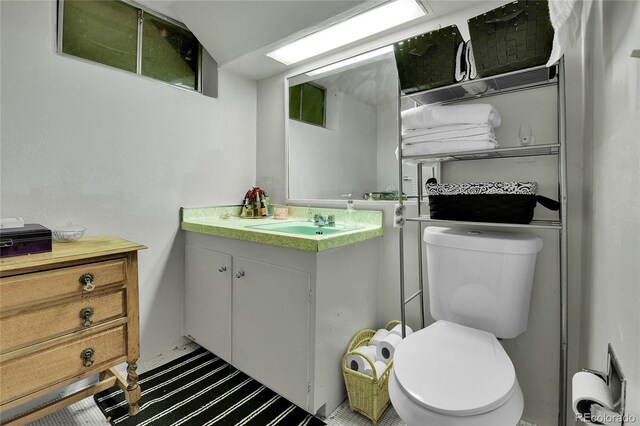 half bath featuring toilet and vanity