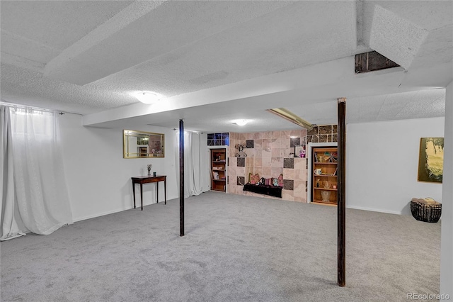 finished below grade area featuring a textured ceiling and carpet flooring