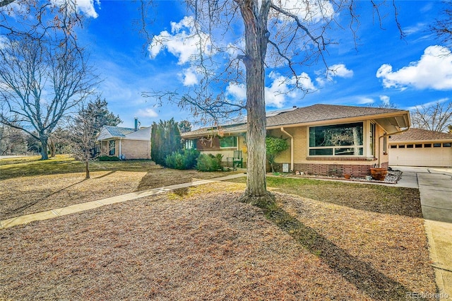 ranch-style house with brick siding, a front yard, and a shingled roof