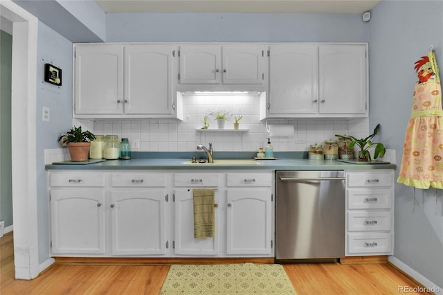 kitchen featuring light wood-type flooring, tasteful backsplash, white cabinets, and dishwasher