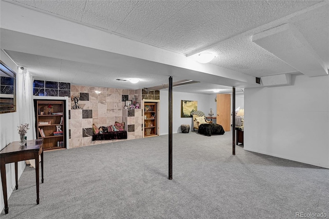 finished basement featuring carpet floors and a textured ceiling