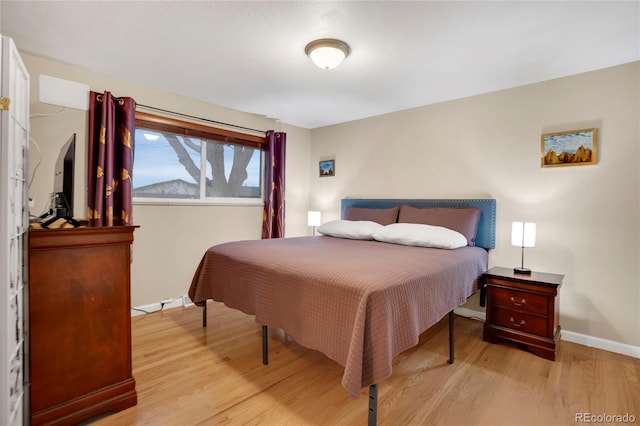 bedroom featuring baseboards and wood finished floors