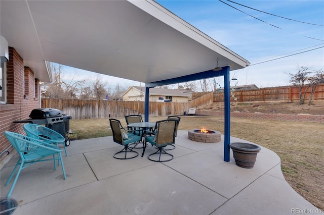 view of patio featuring an outdoor fire pit, a grill, and a fenced backyard