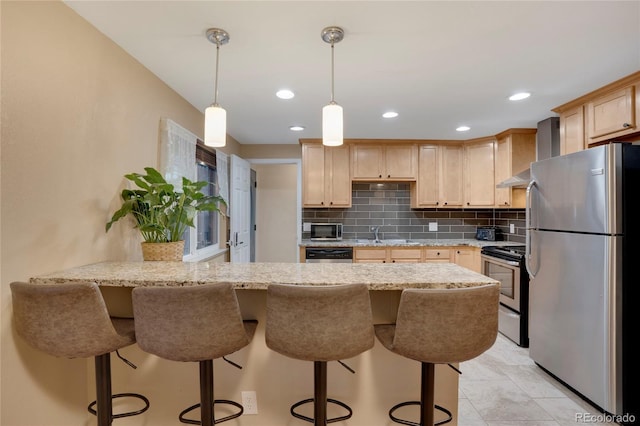 kitchen with decorative backsplash, appliances with stainless steel finishes, light brown cabinets, a peninsula, and wall chimney exhaust hood