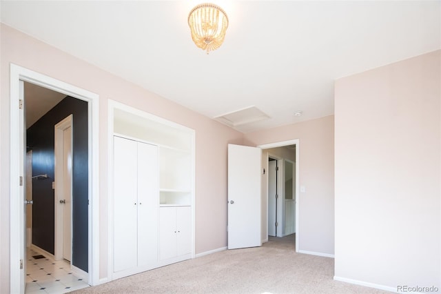 unfurnished bedroom featuring baseboards, light carpet, and a closet