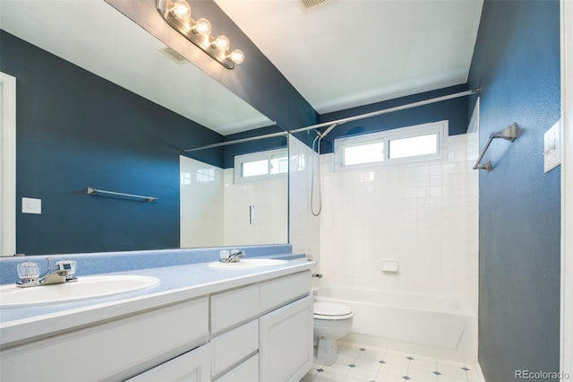 bathroom with double vanity, toilet, shower / bath combination, and a sink