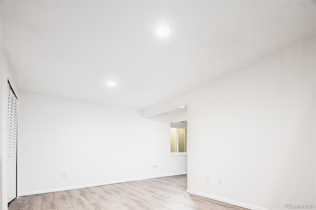 unfurnished room featuring recessed lighting, baseboards, and wood finished floors