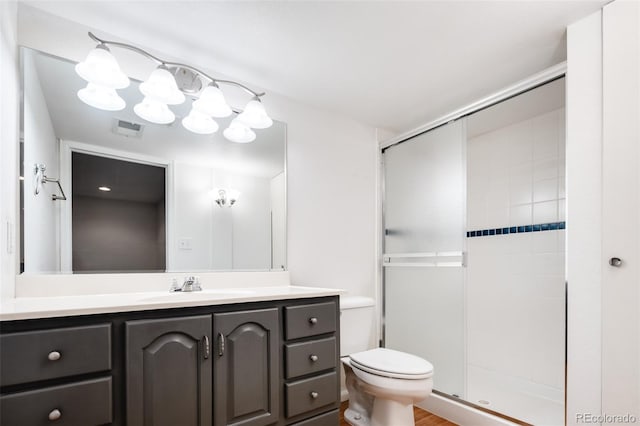 full bathroom with vanity, toilet, visible vents, and a stall shower