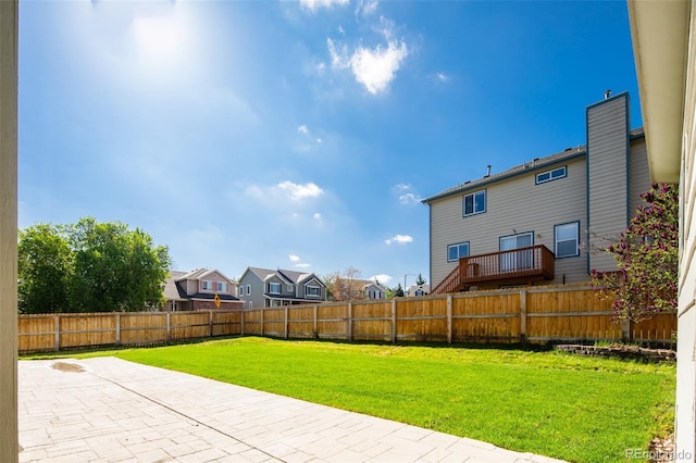 view of yard featuring a fenced backyard, a patio, and a residential view