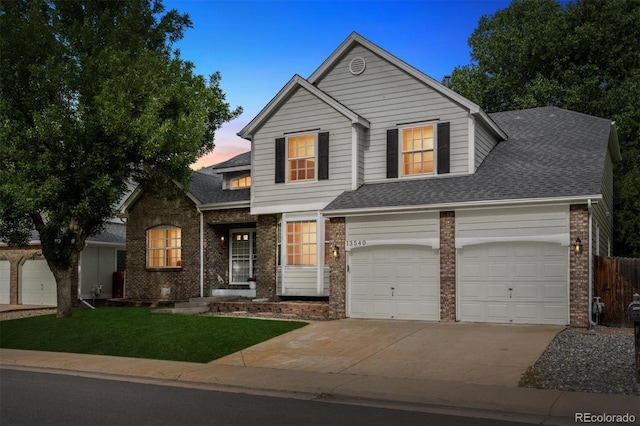 13540 Detroit St, Thornton, CO 80241 - traditional-style house with brick siding, driveway, a shingled roof, and an attached garage