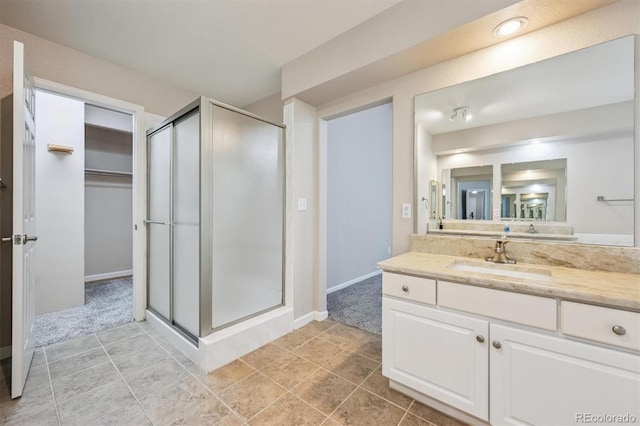 13540 Detroit St, Thornton, CO 80241 - bathroom featuring a stall shower, vanity, and a walk in closet