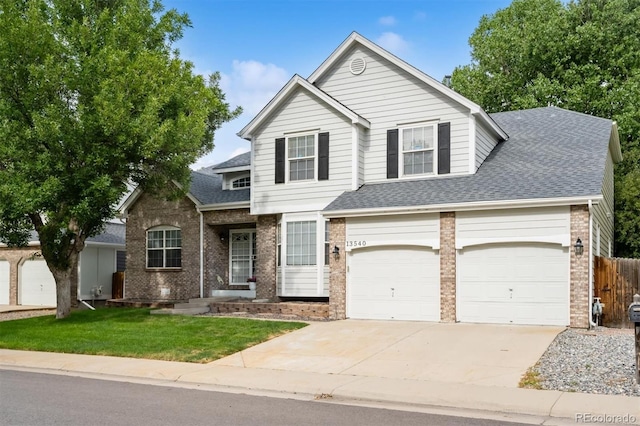 13540 Detroit St, Thornton, CO 80241 - traditional-style home with brick siding, driveway, and a shingled roof