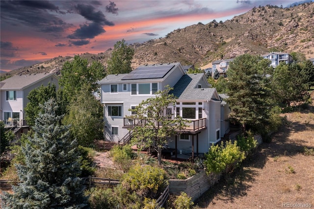 aerial view at dusk featuring a mountain view