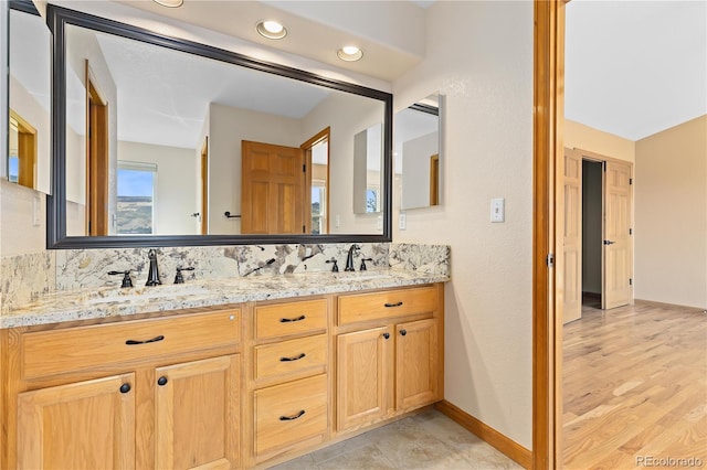 bathroom with vanity and decorative backsplash