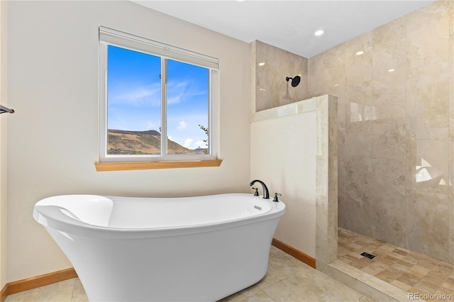 bathroom featuring independent shower and bath, tile patterned flooring, and a mountain view