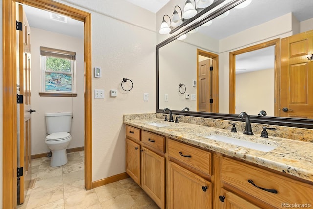 bathroom with vanity and toilet