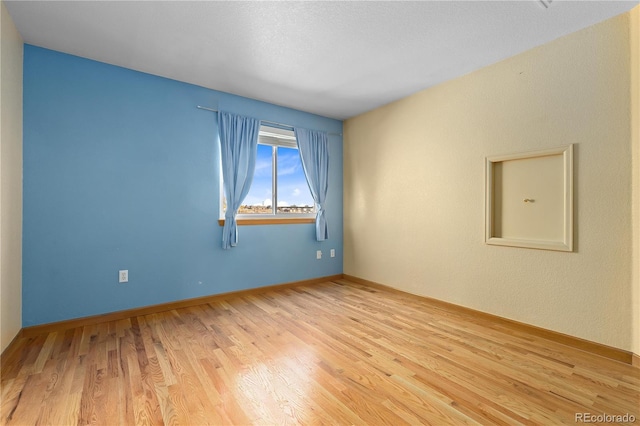 unfurnished room featuring light hardwood / wood-style floors