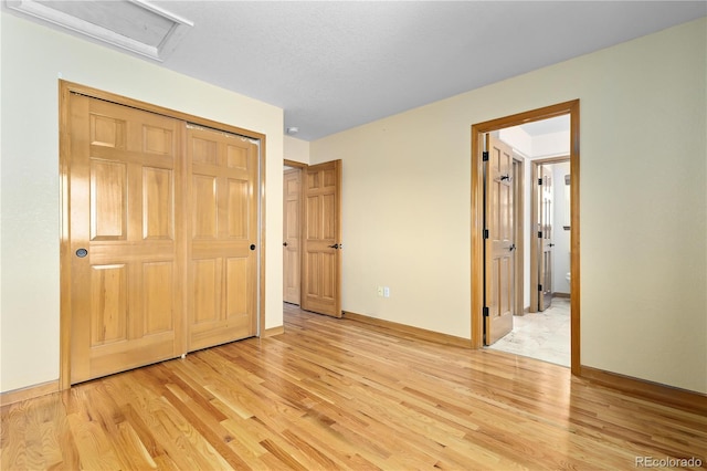 unfurnished bedroom with light hardwood / wood-style floors and a closet