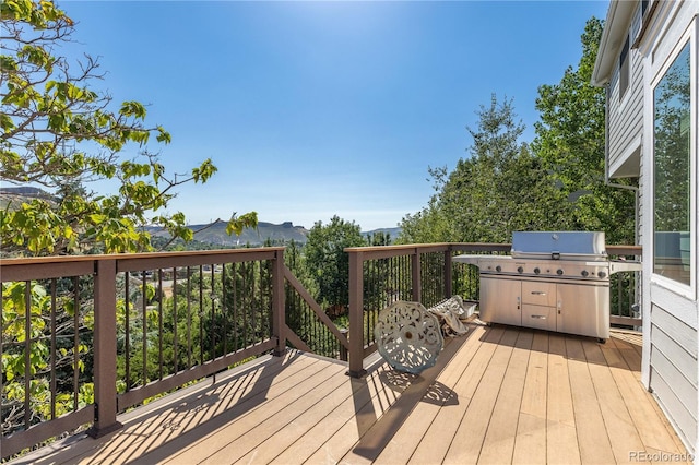 wooden terrace with a mountain view and grilling area