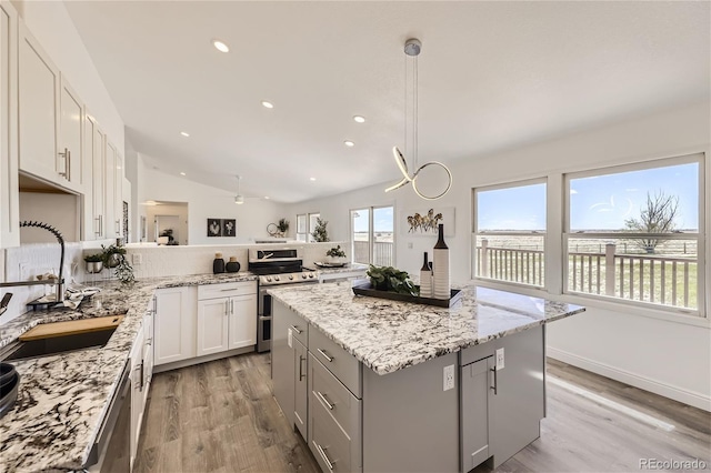 kitchen featuring white cabinetry, sink, a center island, and appliances with stainless steel finishes