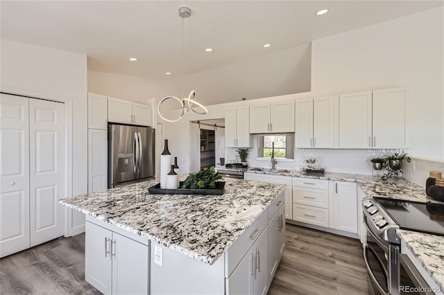 kitchen featuring white cabinets, appliances with stainless steel finishes, and a center island