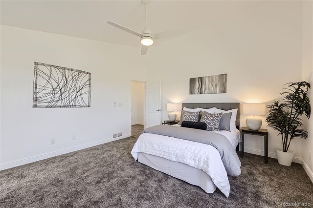 bedroom with ceiling fan and dark carpet