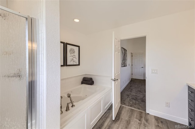 bathroom with vanity, wood-type flooring, and shower with separate bathtub