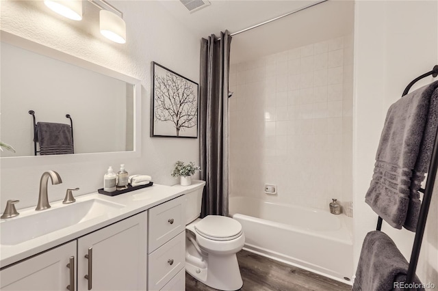 full bathroom featuring shower / bath combo with shower curtain, vanity, wood-type flooring, and toilet