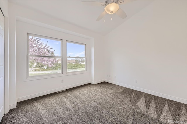 empty room featuring ceiling fan, lofted ceiling, and carpet floors